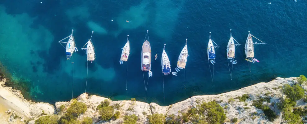 Aerial view of sailboats anchored near Dubai coastline